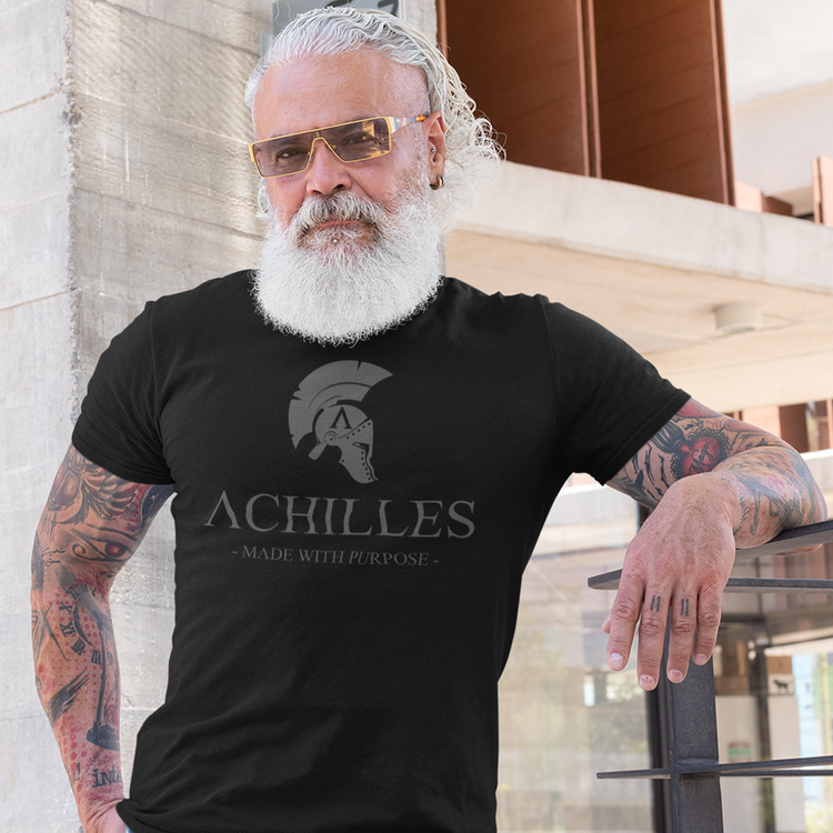 bearded man wearing a black short sleeve cotton original t-shirt from Achilles Tactical Clothing Brand with grey named logo across chest