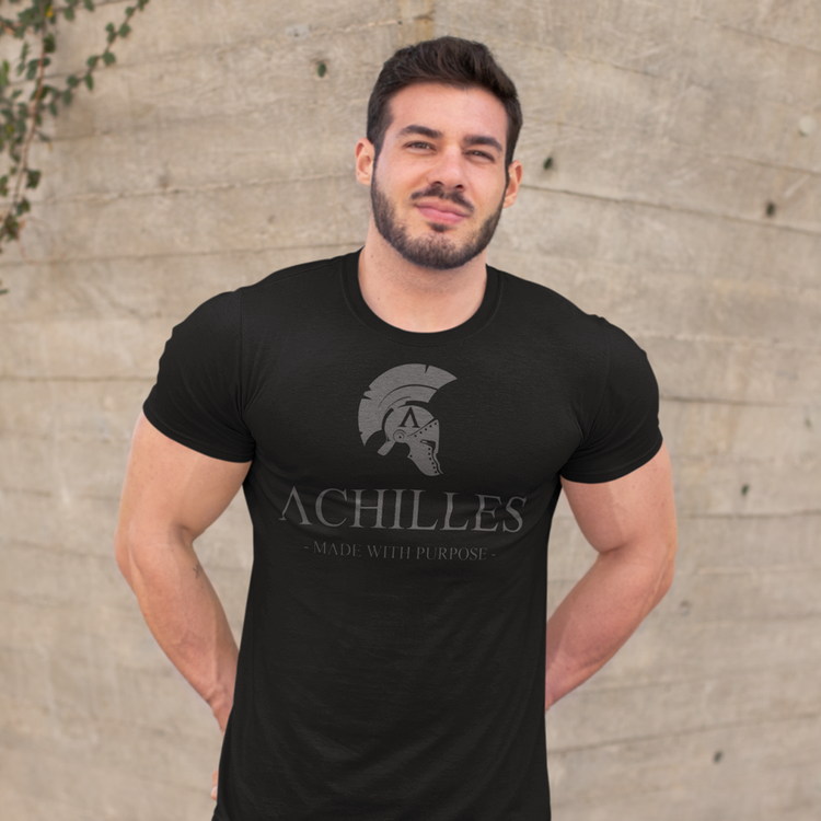 front view of man wearing black cotton short sleeve T-shirt from Achilles Tactical Clothing Brand with Signature design across chest