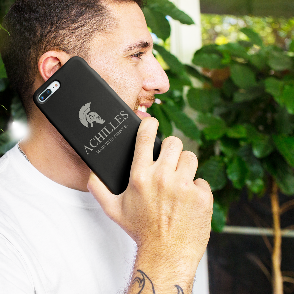 Side view of man holding phone to ear with black Achilles Tactical Clothing Brand tough phone case